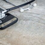 Diagnostic Tools - a phone with a stethoscope on top of it