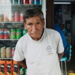 Refrigerants - A man standing in front of a store with a lot of products