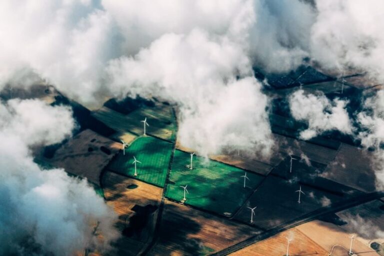 Renewable Energy - aerial photo of wind turbines near field
