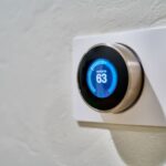 Smart Thermostats - gray Nest thermostat displaying at 63