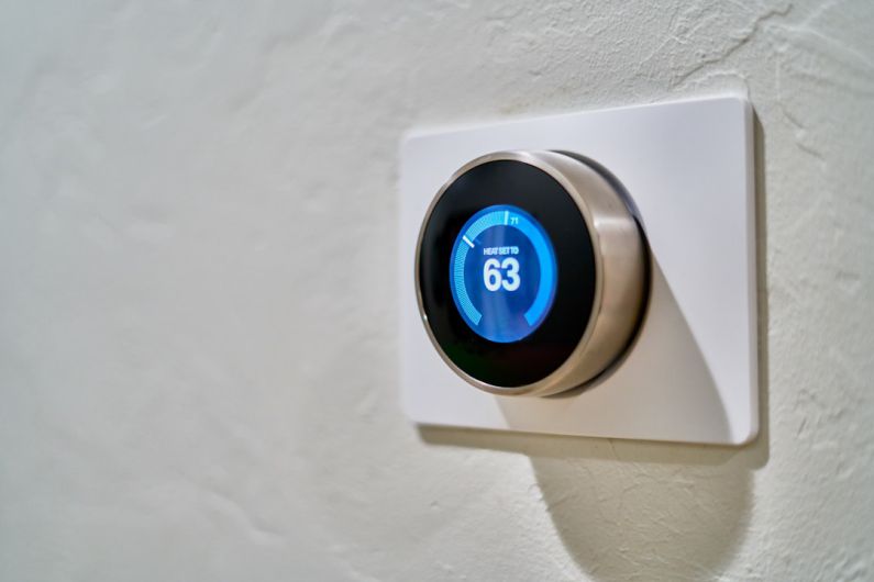Smart Thermostats - gray Nest thermostat displaying at 63