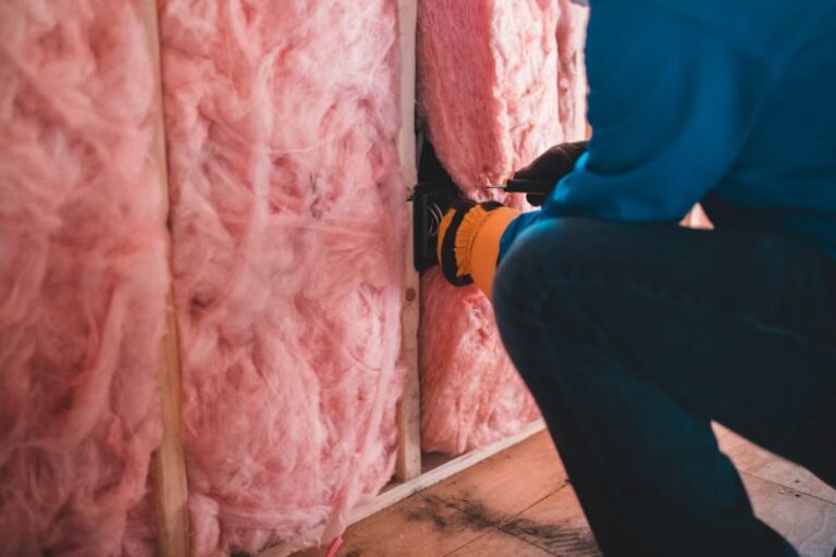 Insulation - person in blue pants sitting on brown wooden floor