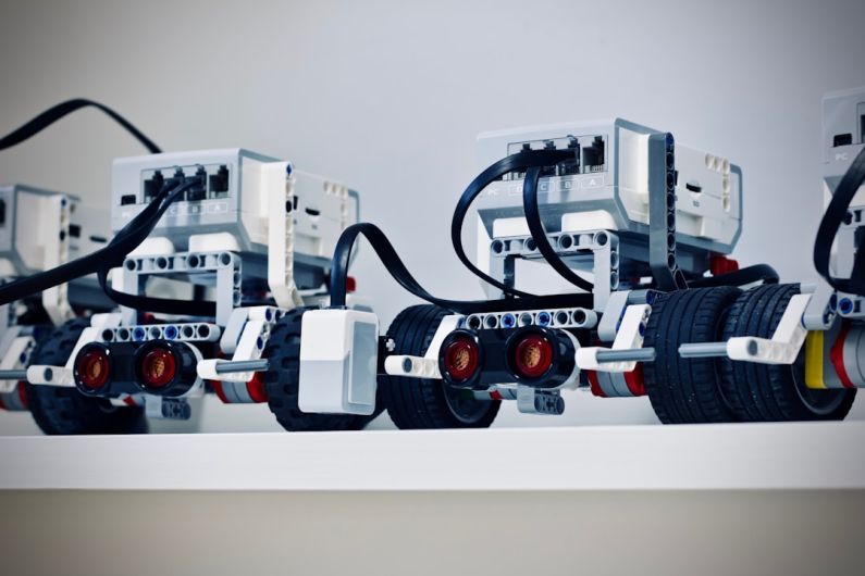 Robotics - two white and black electronic device with wheels