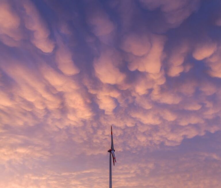 Environmental Impacts - white clouds over the wind turbines