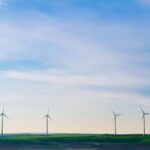 Environmental Benefits - white windmills on green grass field under white clouds and blue sky